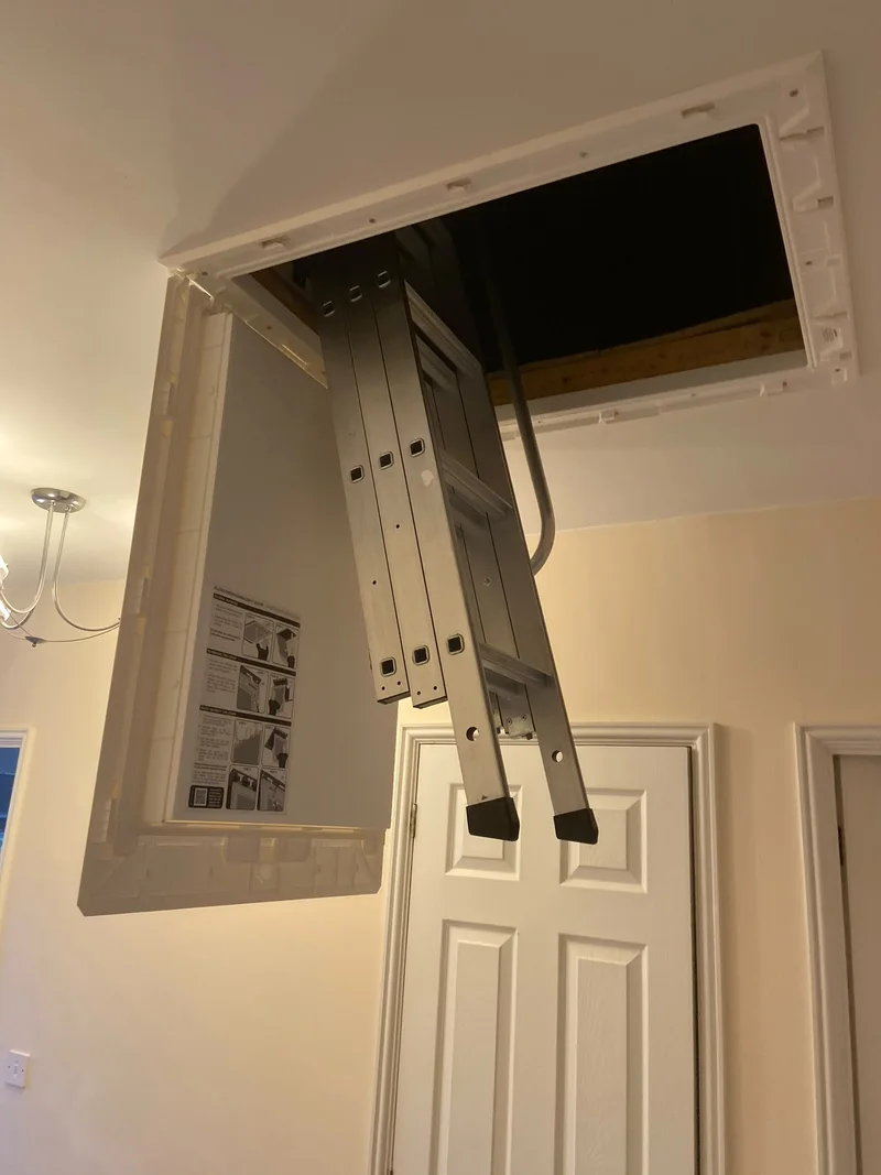 Aluminium loft ladder and open white plastic hatch installed by KMW
